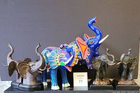 Front view of the full set including all elephant bookends and figurines arranged in a row