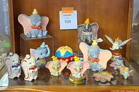 Full group display of Disney Dumbo and elephant-themed ceramic and plastic figurines and collectibles