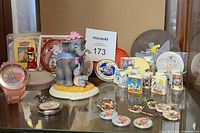 Full view of glass shelf showing all Dumbo and related items