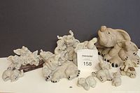 Full lot of 9 Quarry Critters elephant figurines displayed together showing variety of sizes and poses.