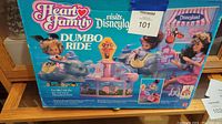 Full view of the Heart Family Dumbo Ride toy box showing the vintage playset and characters.