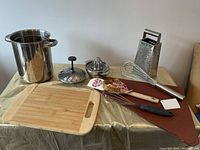 Wide shot of the kitchen items laid on a draped surface showing all included items clearly.