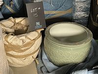 Two large ceramic urns; one wrapped and one unwrapped