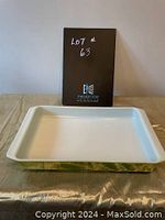 Front view of the rectangular Pyrex lasagna dish showing white interior and green sides with mid-century modern style pattern.