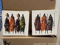 Two original paintings on canvas of Maasai warriors with figures in colorful traditional clothing, showing intricate brushwork and vibrant pigments.
