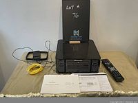 Front view of Marantz M-CR612 with remote, cable and documentation laid out