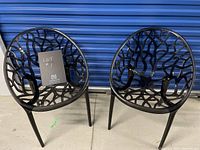 Two chairs front view against blue metal door