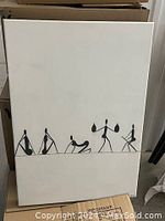 Photo of black and white artwork showing five stylized human figures engaged in different poses on white background