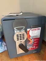 Front view of closed safe showing electronic keypad, black handle and First Alert label
