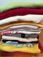 Stack of folded ladies tank tops in various colors and patterns.