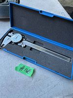 Photo of the 6-inch dial caliper inside original blue plastic case with foam padding, showing full length and storage position.
