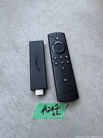 Amazon Fire Stick 4K with remote control shown on a surface with a green note labeled #267 x2.