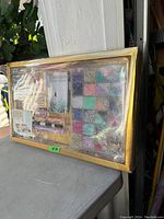 Full view of the unopened boxed craft storage bead case showing multiple small compartments with compartmentalized beads and tools inside.