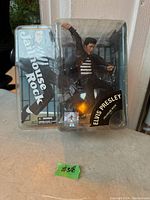 Photo of the Elvis Presley Jailhouse Rock figurine in original clear blister packaging showing figurine and packaging text.