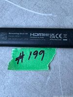 Top view close-up showing the text and certifications on the streaming stick, including model number 3802V and HDMI logo.