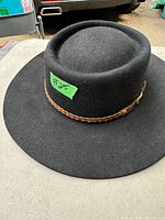 Black felt unisex hat with a braided leather decorative hatband and wide brim.
