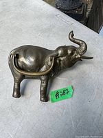 Front view of the brass vintage elephant door knocker showing detailed elephant shape and patina.