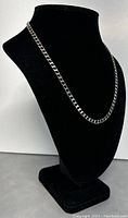 Sterling silver chain necklace displayed on black bust, showing length and link design.