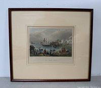 Full view of framed lithograph print depicting harbor scene with ships and people, double matted and wooden framed.