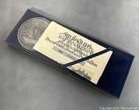 Top view of original box with pewter medallion and certificate inside