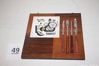 Full view of the wooden cutting board with ceramic tile and four bar tools attached by magnets, showing the item and its layout.