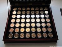 Complete set of 56 gold-plated U.S. State quarters in protective plastic cases displayed in a wooden box.
