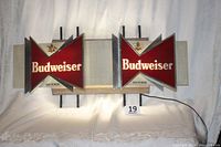 Photo of the lighted Budweiser bar sign showing front view with two red bowtie panels and Anheuser Busch eagle logos.
