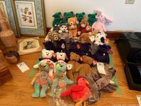 Overview of multiple Ty Beanie Babies toys including bears, a monkey, and other animals.