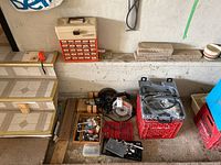 Photo showing various tools laid out including a multi-drawer caddie, skill saw, drills, bits, and miscellaneous hardware.