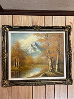 Framed oil painting of a creek, mountain, and autumn trees scene with vibrant brushwork and color.