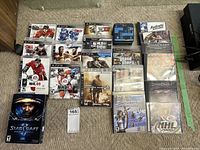 Photo showing assortment of PS3 and PC games including NHL 09, NHL 13, WWE 12, MLB 09 The Show, Fight Night Round 4, Call of Duty Modern Warfare, UFC Undisputed, Sports Champions, Grand Theft Auto IV, and PC games such as StarCraft series, Half-Life, and NHL 2000.