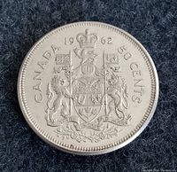 Obverse side of the 1962 Canadian silver 50 cents coin showing the Canadian coat of arms and denomination.
