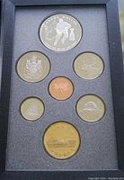 Front view of the entire 1993 Royal Canadian Mint Proof Set showing all seven coins in black foam packaging. Includes the silver commemorative Stanley Cup dollar coin, gold-toned dollar coin, and five smaller coins with Canadian motifs.