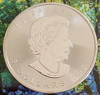 Obverse side of the silver coin showing Queen Elizabeth II profile and inscriptions.