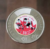 Reverse side showing colored design of two hockey players and 'THE SERIES - LA SERIE' with '50 YEARS ANS'