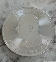 Obverse side showing King Charles III profile, inscriptions including denomination and year