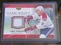Front of Larry Robinson 2007 Upper Deck Game Jersey card showing player image and embedded jersey swatch.