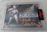 Front of the hockey card showing Larry Robinson image, autograph in blue ink, numbered 2/30, and decorative design elements.