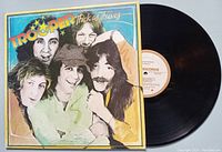 Front cover of Trooper Thick as Thieves album and black vinyl record.