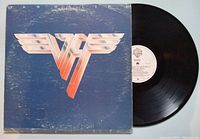 Vinyl record partially inside album cover showing front cover design and part of the black record