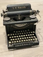 Front view showing keyboard, platen, and Branding on paper bail