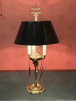 Full view of antique brass Lucerne desk lamp with black shade and hanging brass wick maintenance tools including scissors