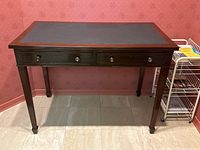 Full front elevation of mahogany desk showing two drawers and leather inset top