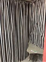 Three black and grey vertical striped curtain panels hung showing gathered tops and full length.
