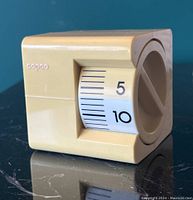 Side view of cube timer showing timer scale with minute markings and 'copco' logo on the side.