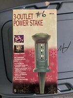 Photo of the boxed 3-Outlet Power Stake showing front panel and key features.