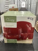 Photo of the Canopy Daily Dish Collection Stoneware Dinnerware Set box showing it is an 18-piece set with red stoneware dishes.