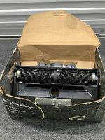 Kraemer Carpet Shampoo System with brush roller inside original worn cardboard box showing wear and damage.