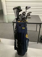 Cleveland golf bag filled with golf clubs including visible headcovers