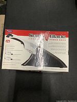 Original boxed Sonic Blade cordless power knife on black surface.